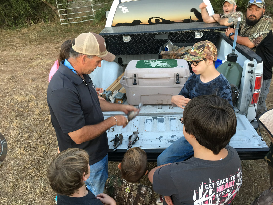 Wooden discs that say hunt with heart and a pile of bullets