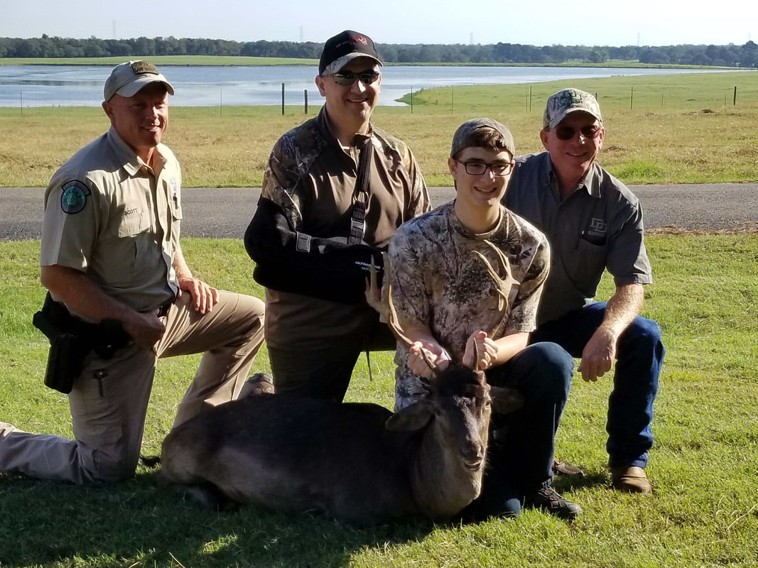 Boys on top of a car looking through binoculars