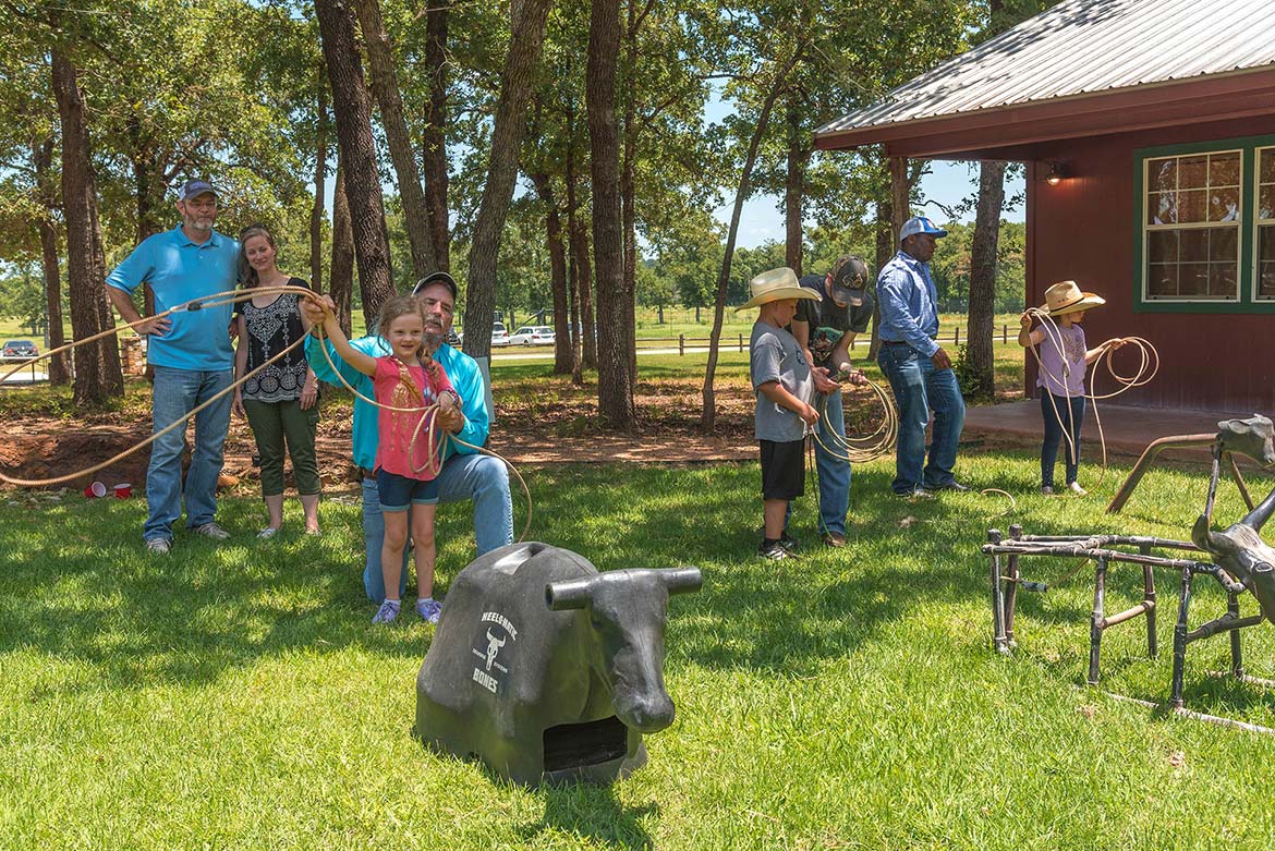Group of people in displaying their recent hunting kills