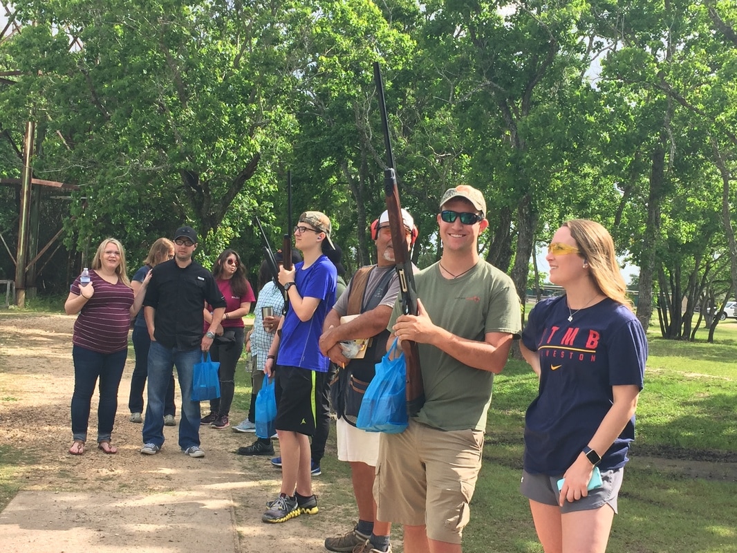 Boys on top of a car looking through binoculars