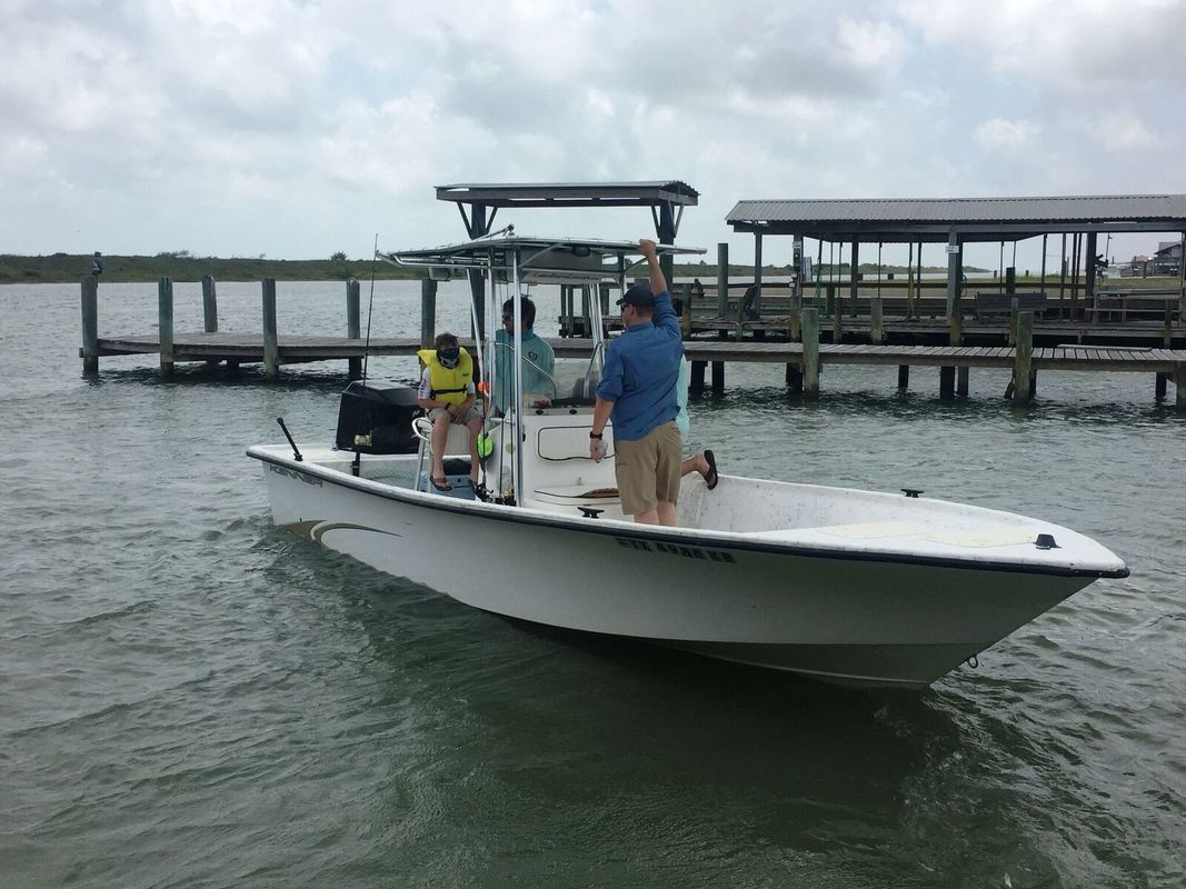 Boys on top of a car looking through binoculars