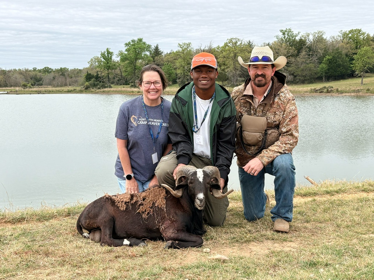 Group of people in displaying their recent hunting kills